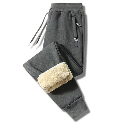 👖【M-5XL】Zimowe męskie spodnie sportowe na zimę 2025 z grubym ociepleniem z futerka owczego, casualowe, ciepłe i komfortowe.